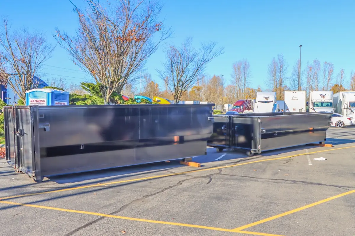Professional dumpster rental service with roll-off container on residential driveway in White Oak